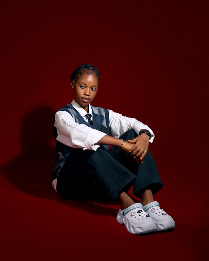 stylish-young-woman-in-casual-attire-on-red-backdrop-34598343